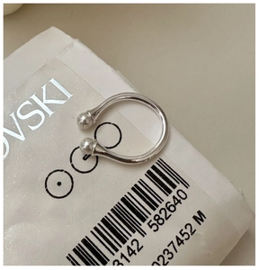 Detail view of a minimalist S925 sterling silver open ring featuring dual white pearls