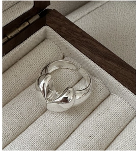Macro detail of sculptural S925 sterling silver heart ring in a luxury jewelry box