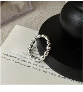 Macro shot of S925 sterling silver heart chain ring with polished linked heart design