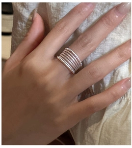 Detail of layered S925 sterling silver multi-strand ring with beaded texture on finger