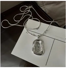 Detailed view of S925 sterling silver stamp on a vintage fluid rectangular pendant