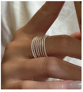 Macro shot of S925 sterling silver multilayer twisted rope rings on a finger