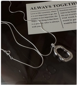 Detailed view of polished S925 silver oval pendant on a sleek snake chain necklace