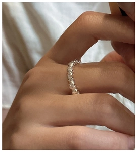 Close-up of minimalist S925 sterling silver twisted ring worn on a woman finger