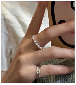 Detail of beaded and lava texture S925 sterling silver rings worn on fingers