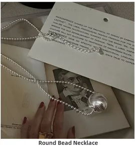 Detailed view of S925 sterling silver bead necklace with spiral textured ball pendant
