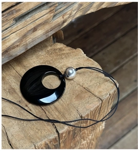 S925 silver sweater necklace featuring a large black obsidian pendant on a rustic wood block