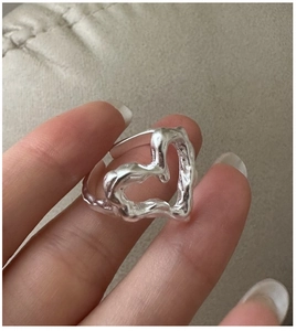 Detailed view of S925 sterling silver heart ring with unique lava texture on finger