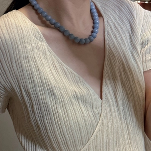 Elegant S925 sterling silver necklace with light blue round beads worn on model
