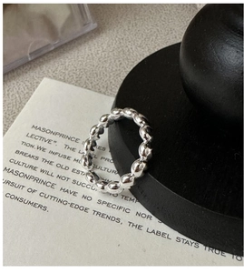 Detail shot of a S925 sterling silver beaded ring with modern industrial texture