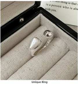 Detailed close-up of S925 sterling silver ring with white shell and hallmark in a box