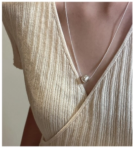 Close-up of S925 sterling silver cat-eye pendant necklace on a bead chain