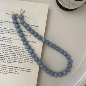 S925 sterling silver blue beaded necklace with toggle clasp on an open book