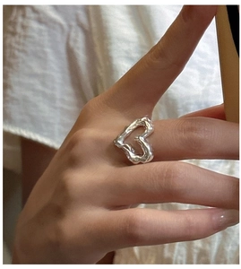 Detailed view of an irregular S925 sterling silver heart ring with molten metal texture