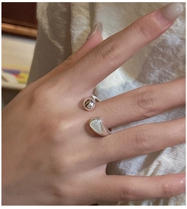 Detail of S925 sterling silver open ring with white shell inlay on female finger