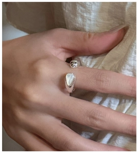 Detail of S925 sterling silver open ring with white shell teardrop and silver bead