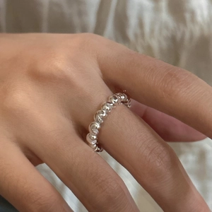 Minimalist S925 sterling silver ring with twisted texture worn on model hand