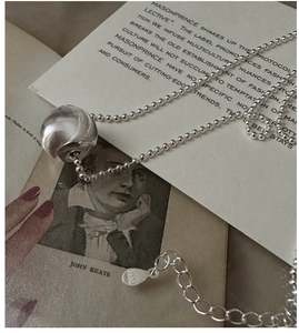 Detailed view of S925 sterling silver ball pendant with spiral texture and lobster clasp