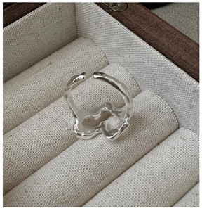 Macro shot of S925 sterling silver stamp on irregular textured wavy adjustable ring