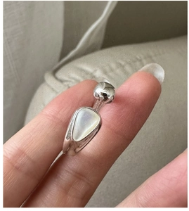 Macro view of S925 silver ring featuring an irregular shell inlay and polished metal ball