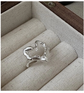 Macro detail of S925 sterling silver heart ring with organic lava texture in a jewelry box