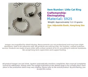 Close-up of S925 sterling silver beaded rings with black cat charms and elastic cord