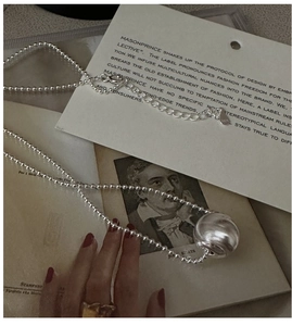 Close-up of S925 sterling silver sphere pendant featuring a matte brushed metal texture
