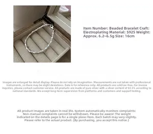 Detailed macro of S925 sterling silver beaded bracelet with polished metallic texture