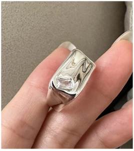Close-up of S925 sterling silver square zircon ring featuring a flowing metal texture design