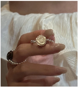 Detail of elegant S925 silver beaded rings with carved rose flower mother of pearl