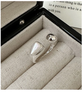 Macro detail of S925 sterling silver ring featuring white shell inlay in a jewelry box
