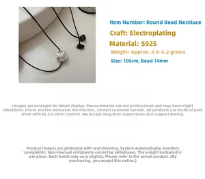 Detailed view of S925 silver round bead necklace on a minimalist black rope cord