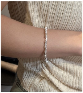 Close-up of S925 sterling silver bracelet with textured link design on model wrist
