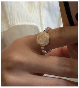 Detail view of S925 sterling silver ring with white shell rose and beaded band