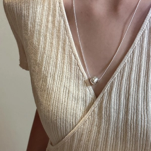 Minimalist S925 sterling silver ball pendant necklace worn on a daily casual outfit