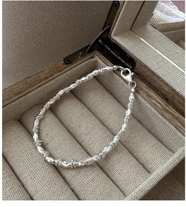 Detailed macro view of S925 sterling silver vintage chain with textured olive beads
