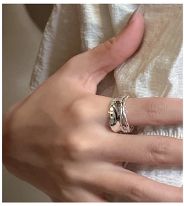 Detail of S925 sterling silver double-layered pleated ring with minimalist texture