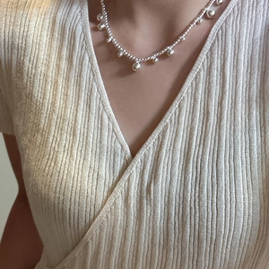 Minimalist S925 sterling silver beaded necklace with small ball charms worn by a model