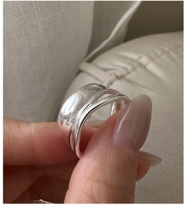 Detailed view of wide S925 sterling silver ring with organic double-layered folds