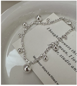 Detailed macro view of S925 sterling silver laser bead bracelet with spherical charms