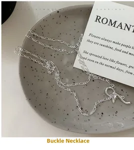 Macro view of a 925 sterling silver layered necklace with unique toggle clasp on a tray