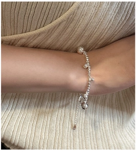 Detail of S925 sterling silver beaded bracelet with alternating laser-cut beads on wrist