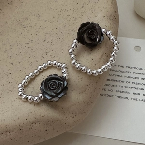 S925 sterling silver beaded rings featuring black resin roses on a stone tray