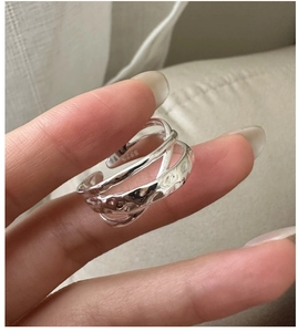 Macro detail of S925 sterling silver ring showing layered liquid lava texture and hallmark