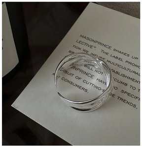 Macro shot of silver textured ring with hammered finish on minimalist card base