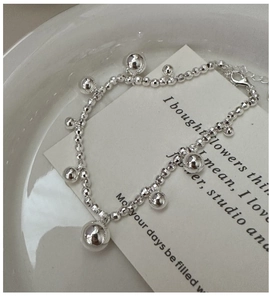 Macro shot of S925 sterling silver beaded bracelet with round charms and lobster clasp
