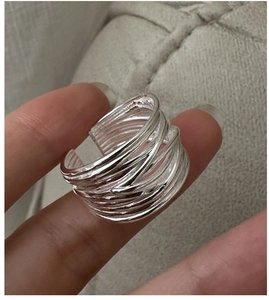 Detailed close-up of multi-layer silver wire wrap ring with elegant minimalist texture