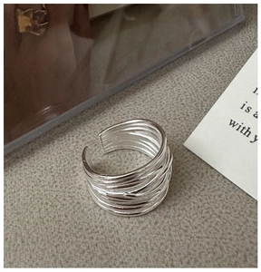 Detail of S925 sterling silver ring showing multi-layered winding textured design