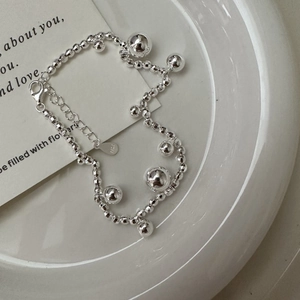 Minimalist S925 sterling silver laser beaded bracelet with lobster clasp on a white plate