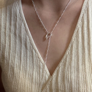 Minimalist S925 sterling silver OT toggle Y-necklace worn on a beige knit sweater